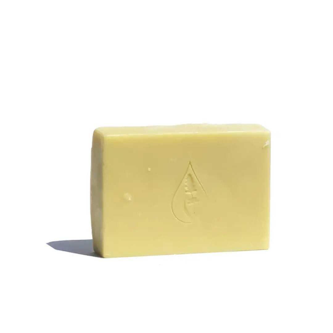 By Valenti pure Castile bar soap with the company's stamped logo on a white background