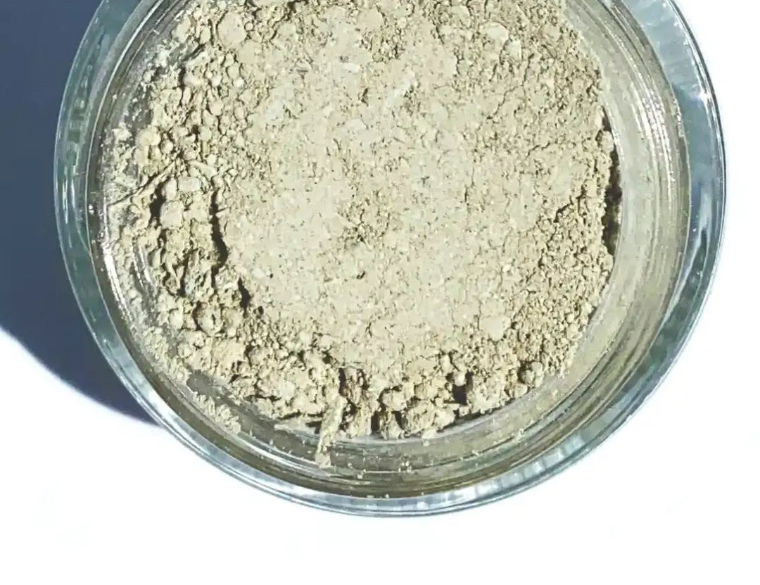Closeup of a jar of By Valenti Japanese Matcha Tea & French Green Clay facial scrubbing clay mask on a white background