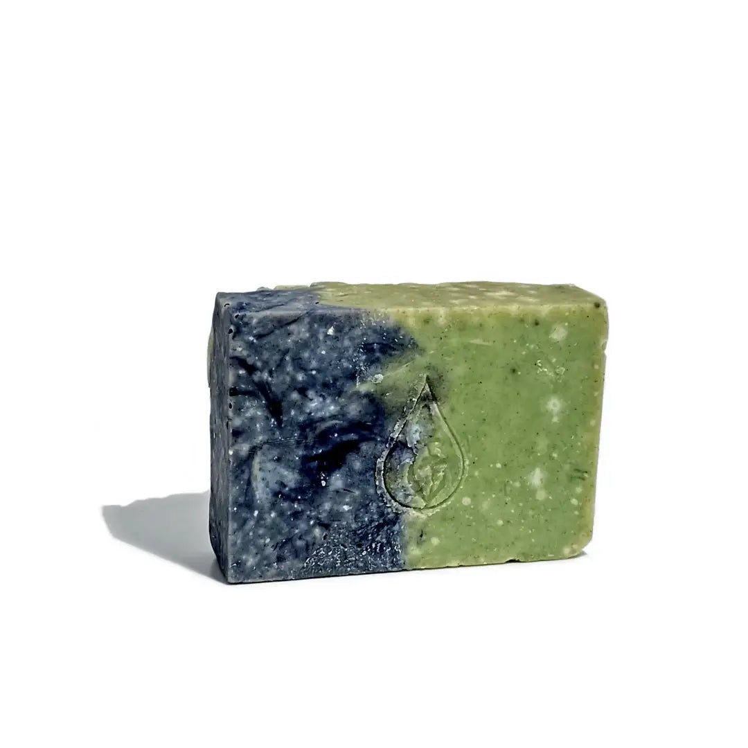 By Valenti two-tone green and blue Pineta Barcola French clay bar soap on a white background