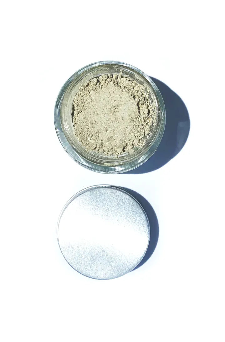 Open jar of BY VALENTI Japanese green clay mask on a white surface