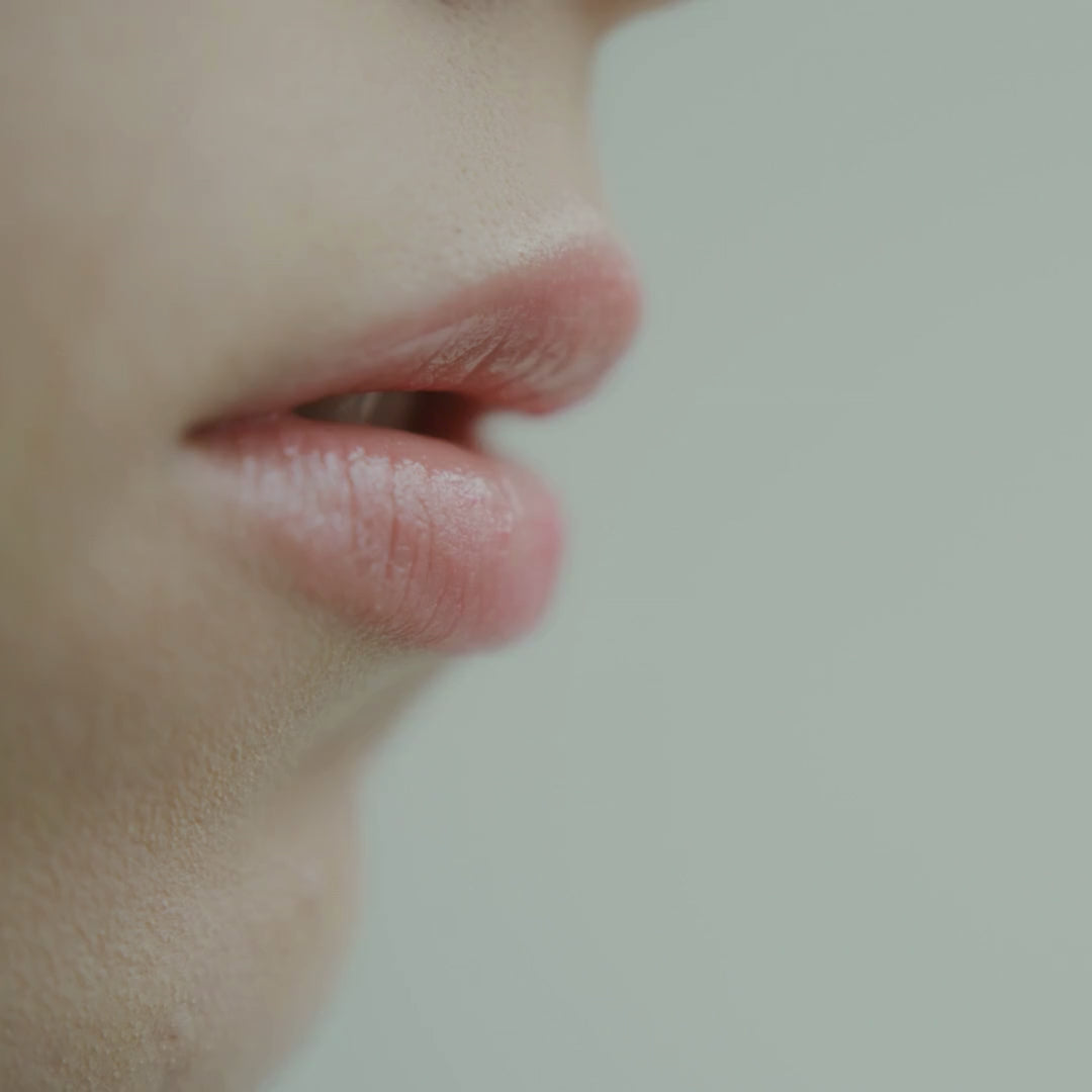 Woman's lips applying By Valenti whipped lip balm